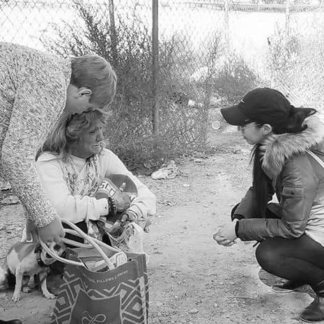 Volontiers and homless woman with dog
